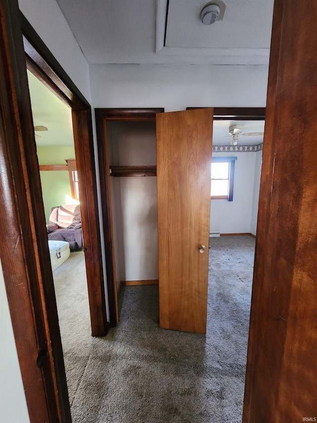 corridor with dark colored carpet