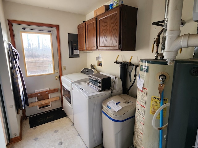 clothes washing area featuring electric panel, washer and clothes dryer, cabinets, and gas water heater