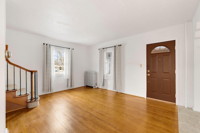 entrance foyer featuring light hardwood / wood-style floors and radiator heating unit