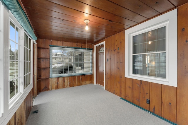 unfurnished sunroom featuring wood ceiling