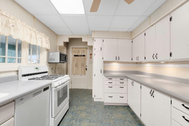 kitchen with white cabinetry, a drop ceiling, ceiling fan, and white appliances