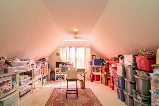 playroom with light carpet, a textured ceiling, and vaulted ceiling