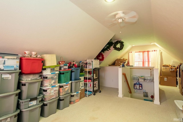 interior space with ceiling fan, light colored carpet, and vaulted ceiling