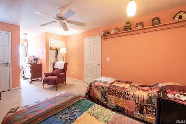 bedroom with ceiling fan and light carpet