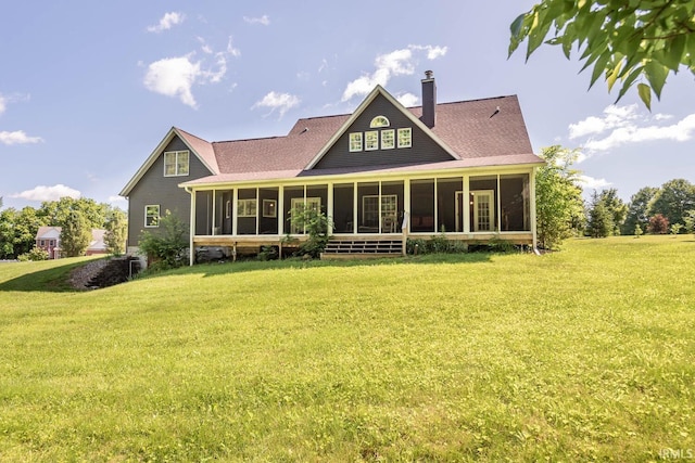 back of house with a sunroom and a lawn