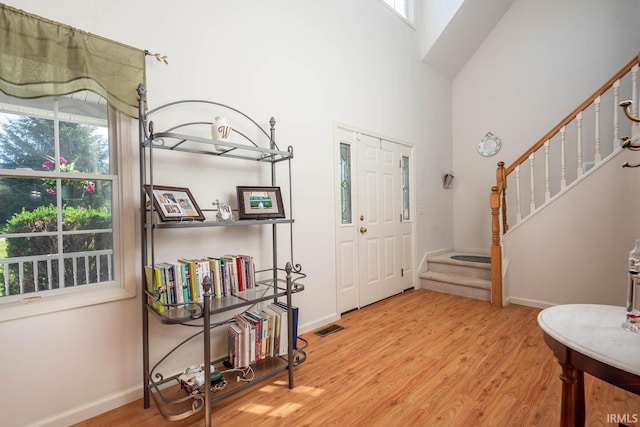 entrance foyer featuring a high ceiling and light hardwood / wood-style floors