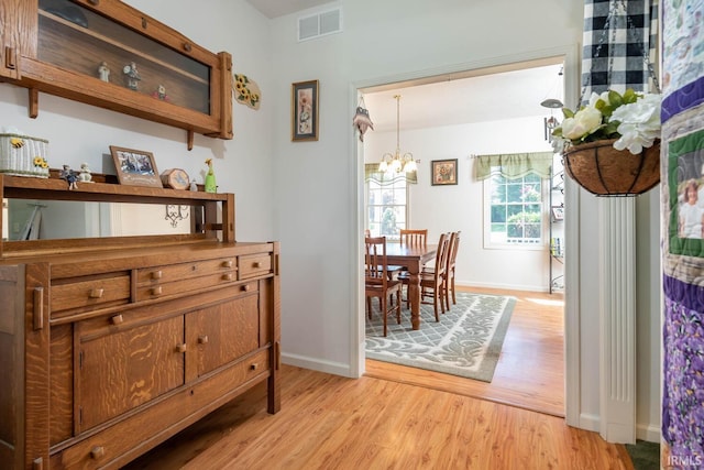 dining room featuring a chandelier and light hardwood / wood-style floors