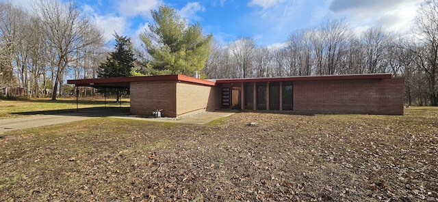 view of property exterior featuring a yard and a carport