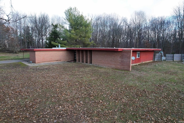 view of side of home with a yard