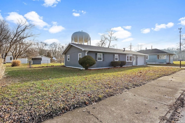 ranch-style house featuring a garage and a front lawn