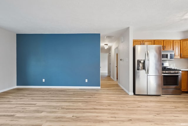 kitchen with stainless steel appliances and light wood-type flooring