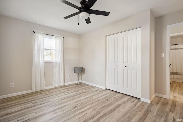 unfurnished bedroom featuring ceiling fan, a closet, and light hardwood / wood-style floors