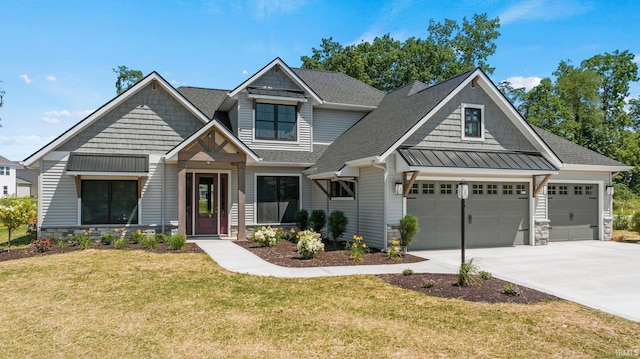 craftsman-style house featuring a front lawn and a garage