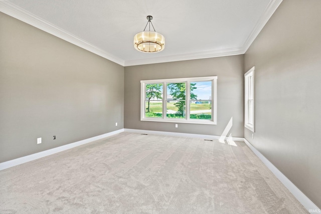 carpeted empty room with a chandelier and crown molding