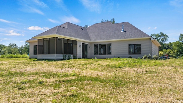 back of property featuring a sunroom and a yard