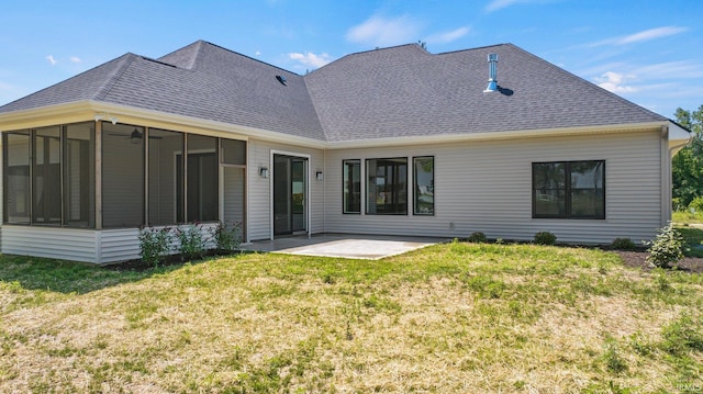 rear view of property with a lawn, a sunroom, and a patio area