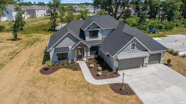 craftsman inspired home with a front lawn and a garage