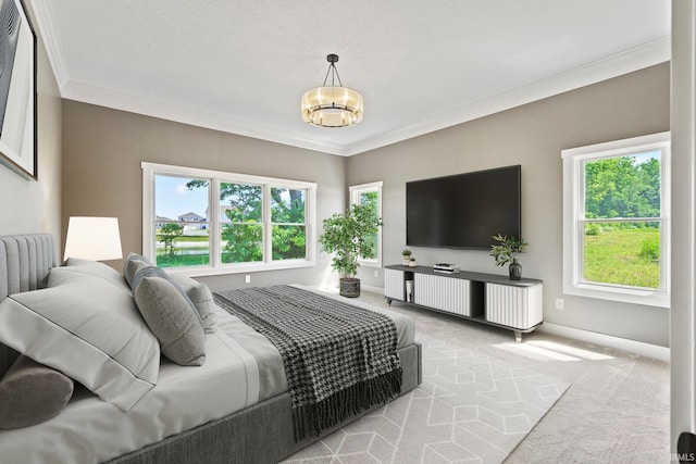 carpeted bedroom featuring multiple windows, a chandelier, and ornamental molding