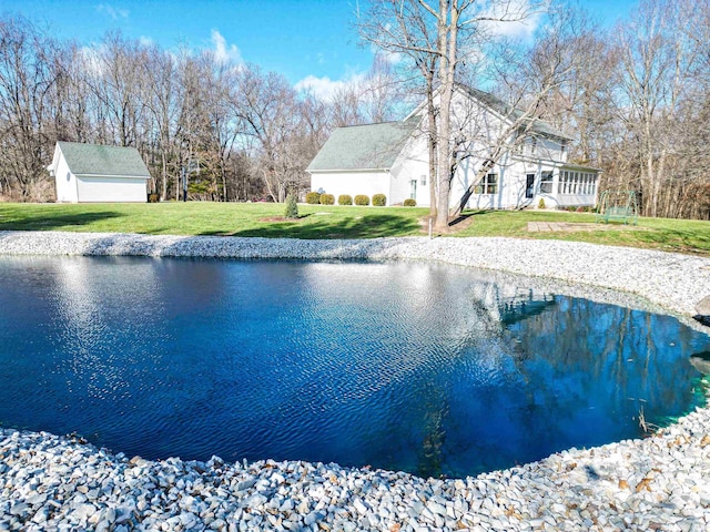 view of swimming pool with a lawn and a water view