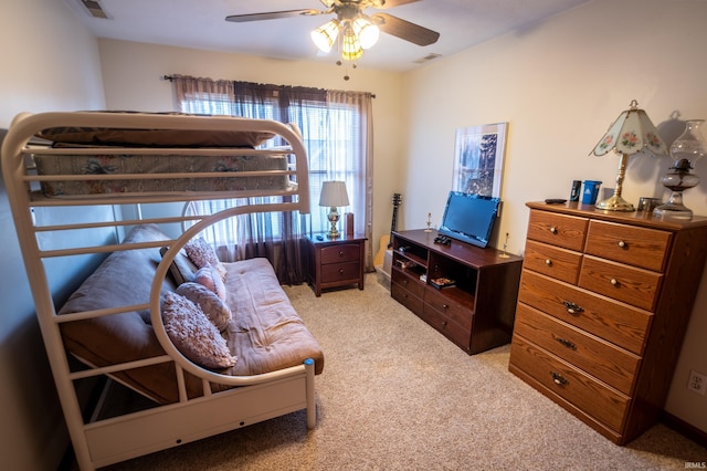 bedroom with ceiling fan and light colored carpet