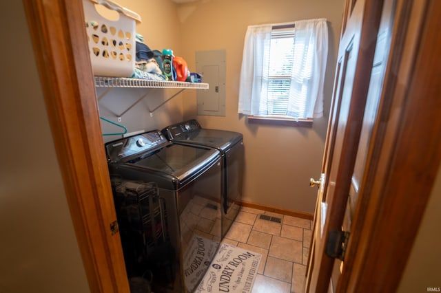 laundry room with electric panel, separate washer and dryer, and light tile patterned floors