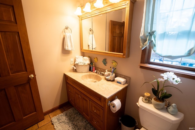 bathroom with tile patterned flooring, vanity, and toilet