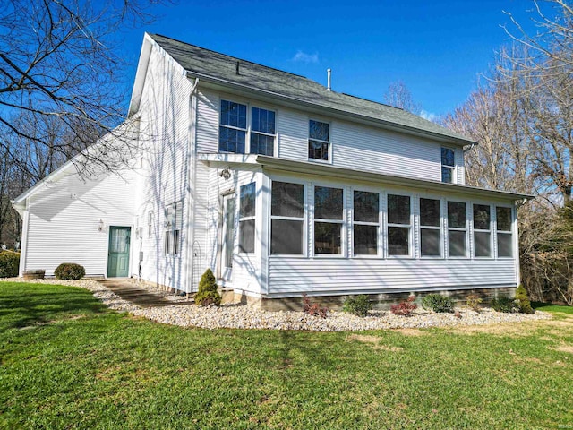 view of property exterior with a sunroom and a yard