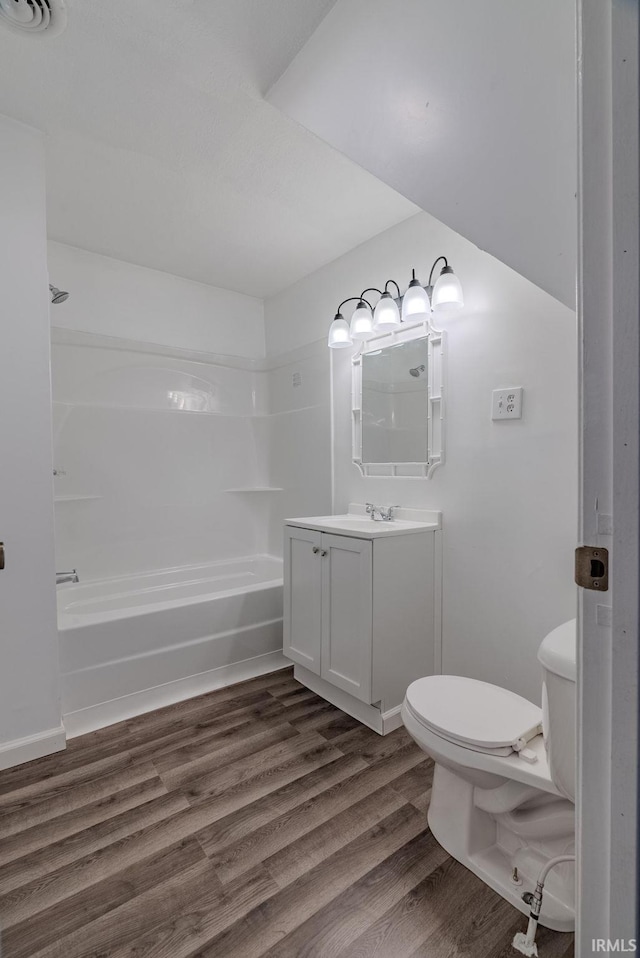 full bathroom featuring hardwood / wood-style flooring, vanity, toilet, and shower / bath combination