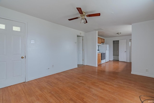 unfurnished living room with ceiling fan and light wood-type flooring