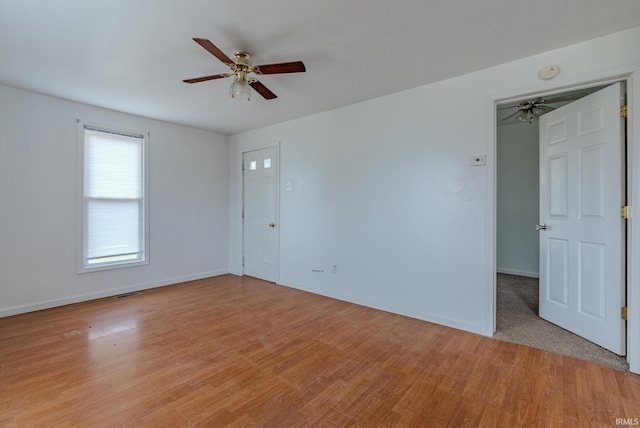 unfurnished room with ceiling fan and light wood-type flooring