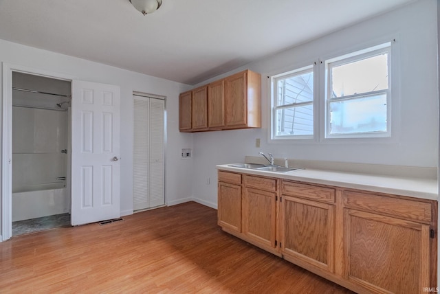 kitchen with sink and light hardwood / wood-style flooring