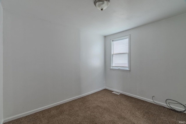 spare room featuring carpet