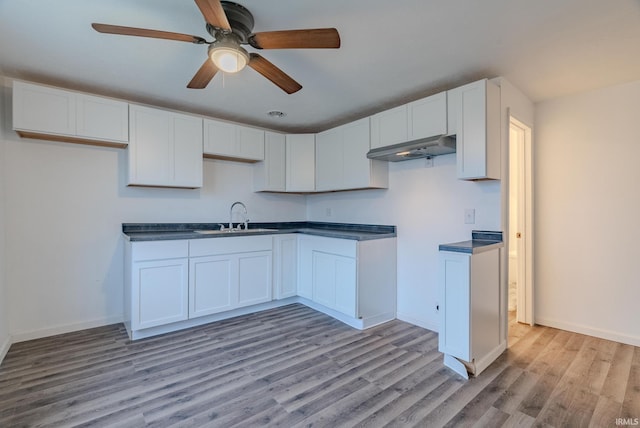 kitchen with white cabinets, ceiling fan, light hardwood / wood-style floors, and sink