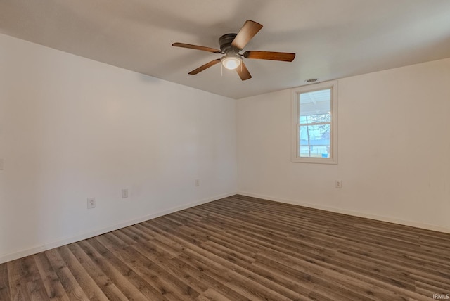 empty room with ceiling fan and dark wood-type flooring