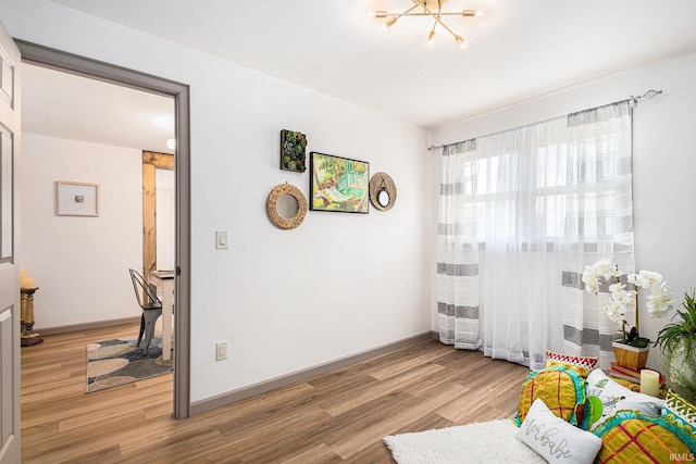 bedroom featuring a chandelier and light wood-type flooring