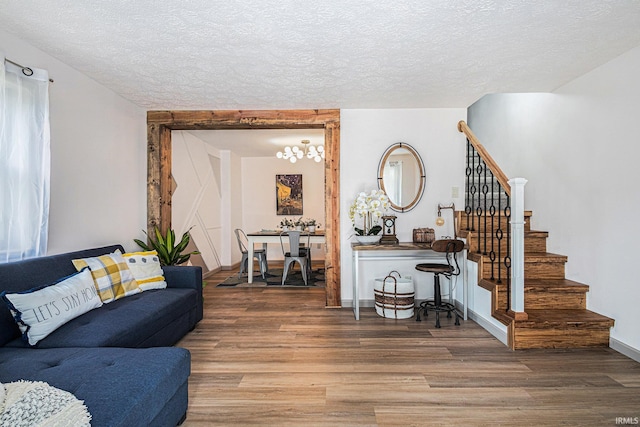 living room with hardwood / wood-style floors and a textured ceiling