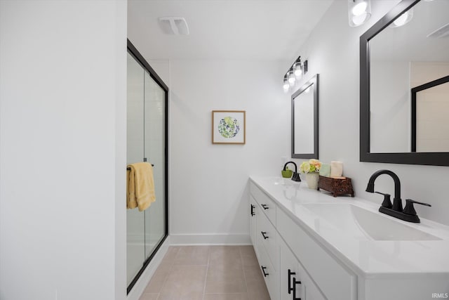 bathroom featuring tile patterned floors, a shower with door, and vanity