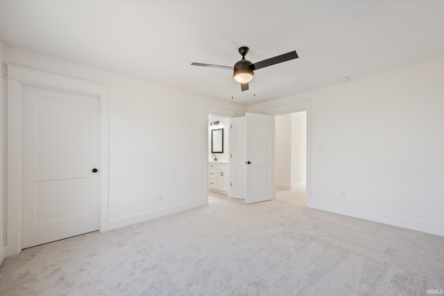 unfurnished bedroom with ceiling fan, light carpet, and ensuite bath