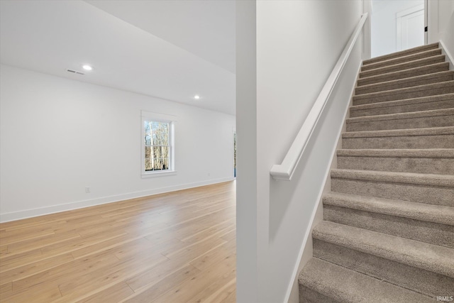 stairs with hardwood / wood-style floors