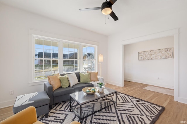 living room with ceiling fan and light hardwood / wood-style floors