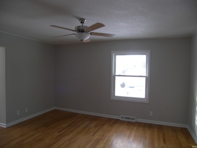 spare room featuring hardwood / wood-style flooring and ceiling fan