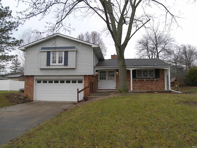 split level home featuring a garage and a front yard