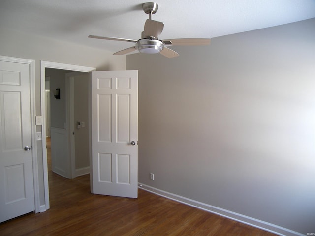 unfurnished bedroom featuring ceiling fan and dark hardwood / wood-style floors