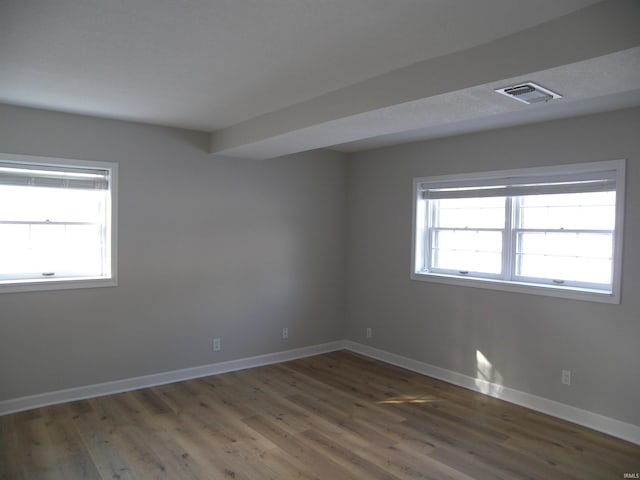 spare room with dark wood-type flooring