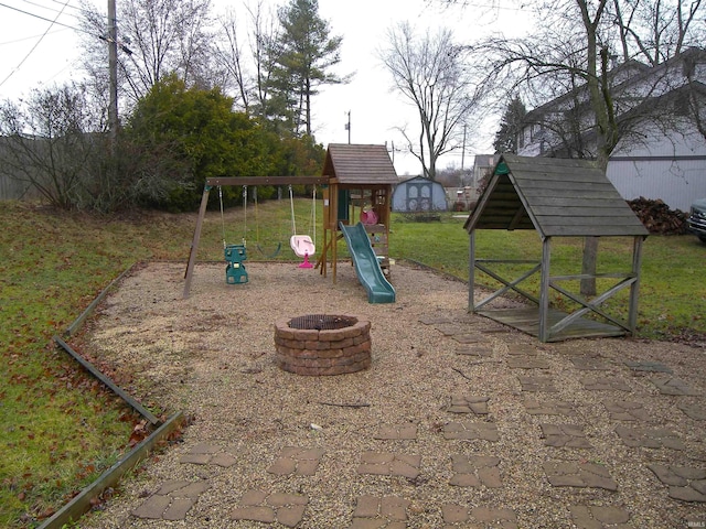 view of playground with an outdoor fire pit