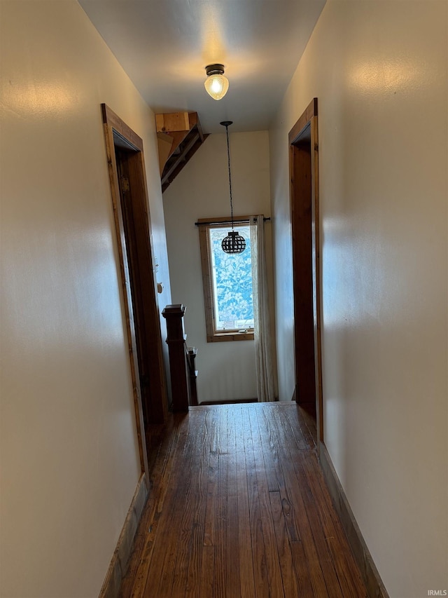 hallway featuring dark hardwood / wood-style flooring and lofted ceiling