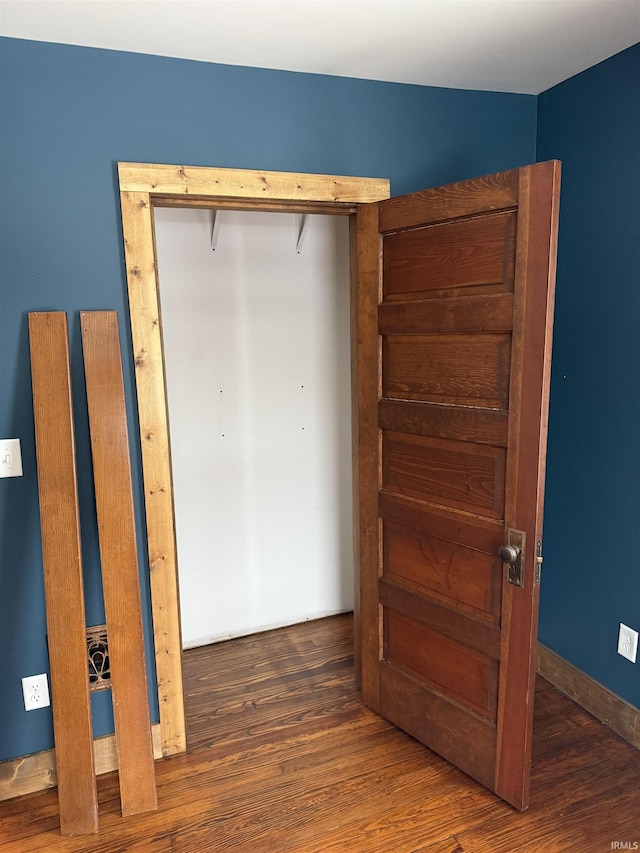 unfurnished bedroom featuring dark hardwood / wood-style floors