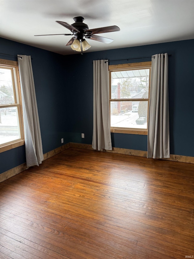 empty room with ceiling fan and hardwood / wood-style floors