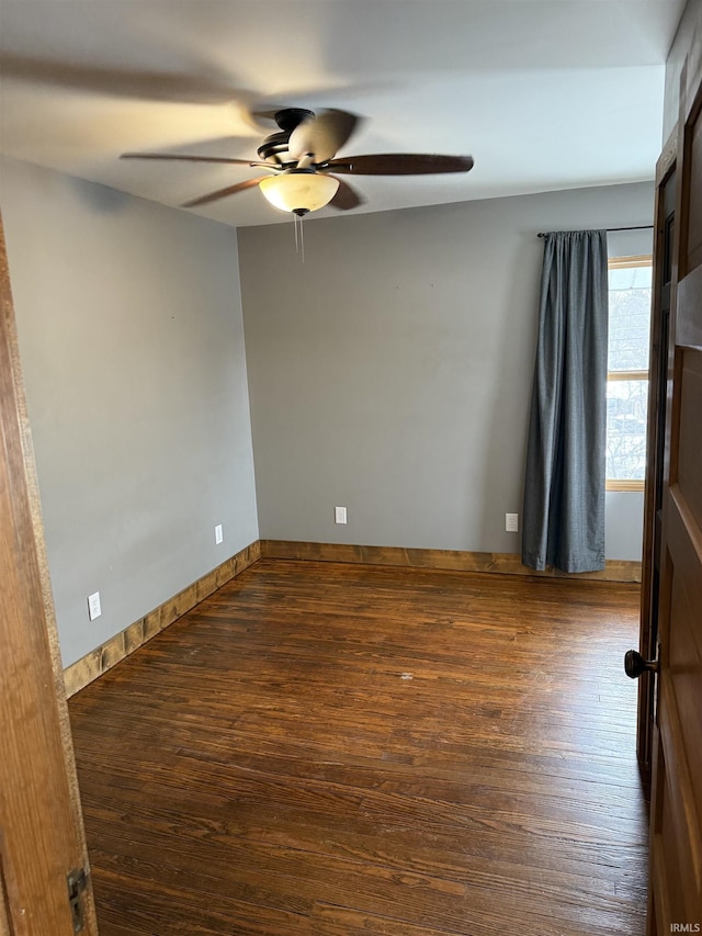 spare room with ceiling fan and dark hardwood / wood-style flooring