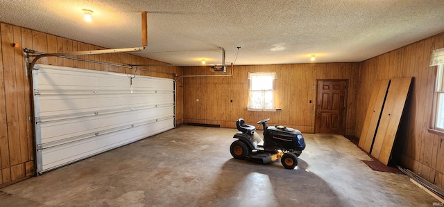 garage featuring wood walls and a garage door opener